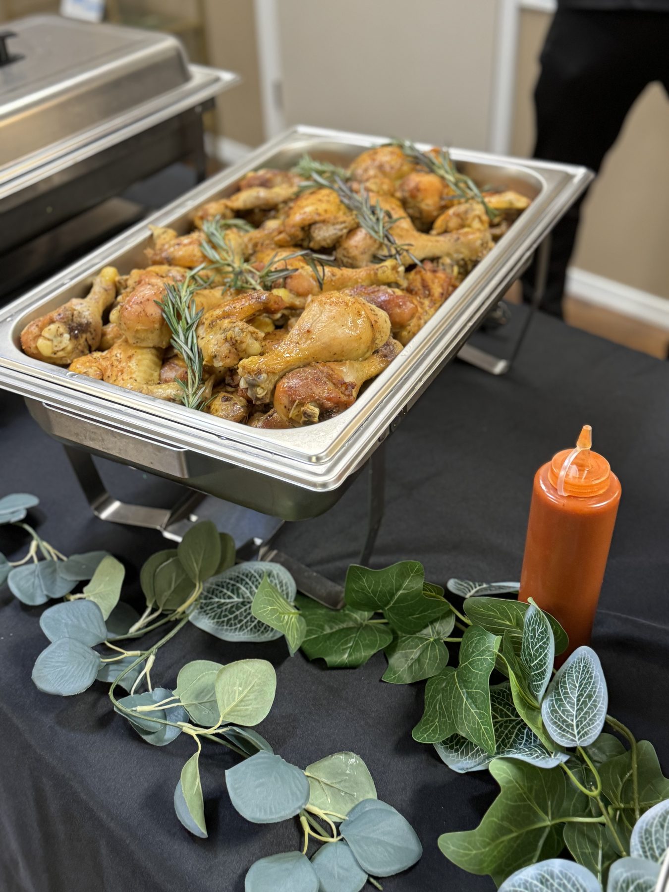 Catering tray of roasted chicken with herbs and vegetables