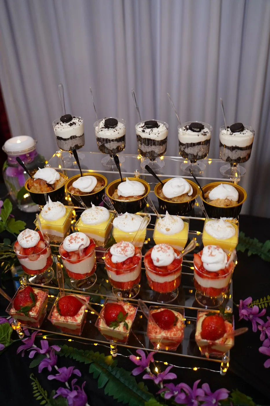 Individual desserts presented on a tiered gold display